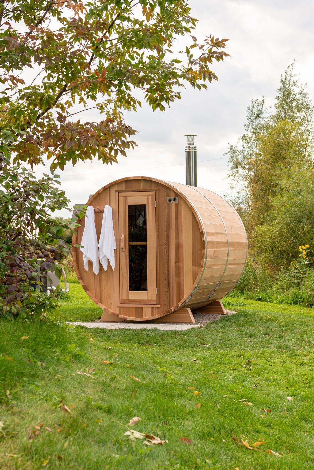 Red cedar barrel sauna in a backyard