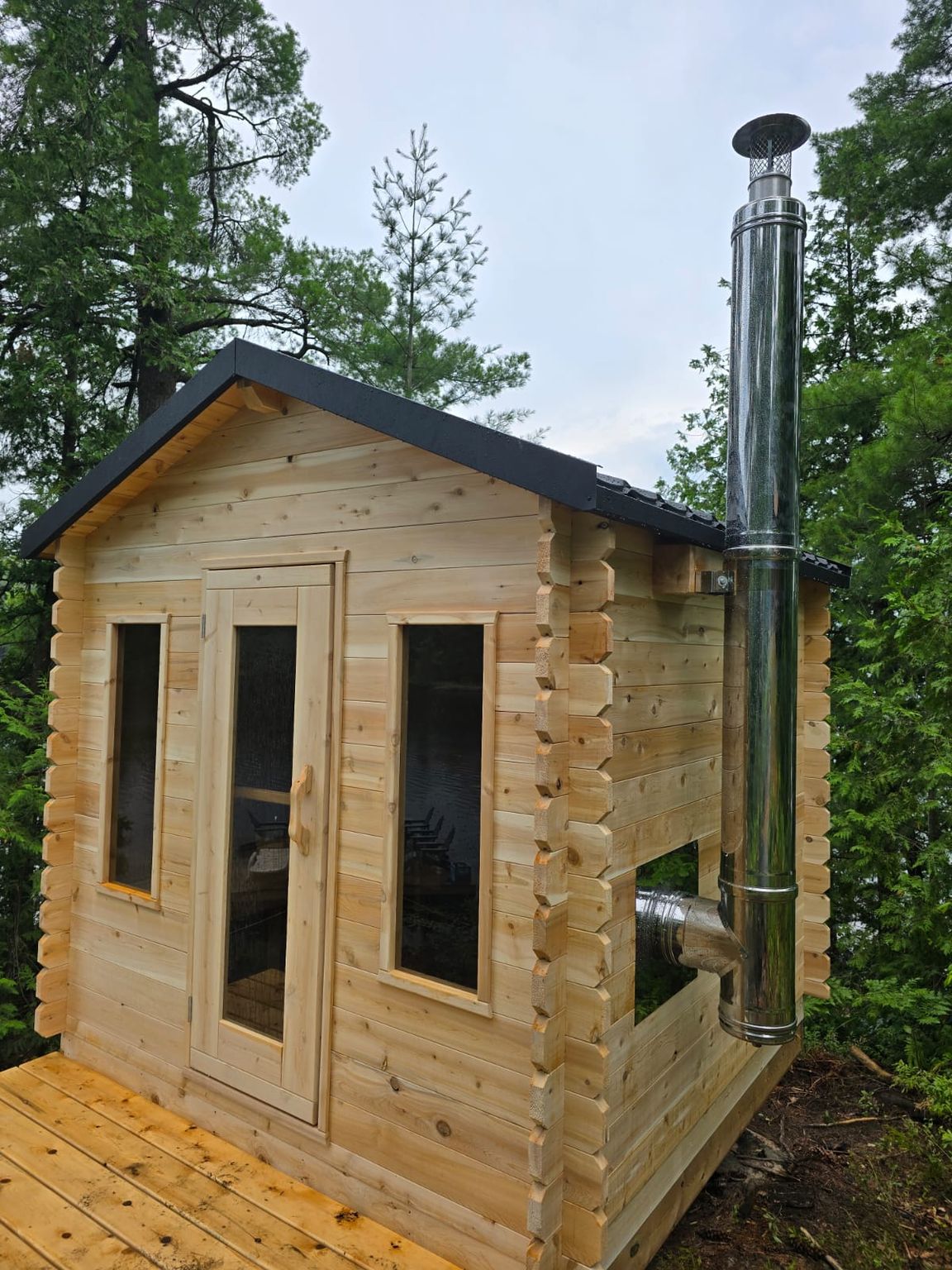 Georgian log cabin sauna with black steel roof